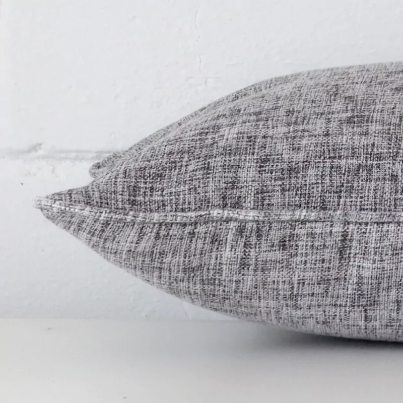 A rectangle linen cushion positioned flat to show its seams. The grey colour is visible as is the seam between the panels.
