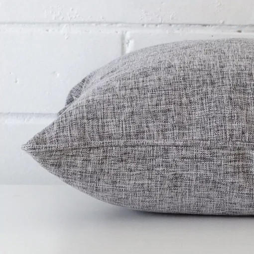 Enlarged image of the side of this grey linen cushion. It has a square design.
