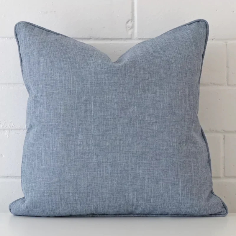 camden-light-blue-cushion-cover-45cm-x-45cm-sc454-45 A lovely square light blue cover arranged in front of a white wall. It has a linen material.
