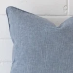 Zoomed photo of the top left corner of this light blue cushion cover. The image clearly shows the linen material and sqaure dimensions.