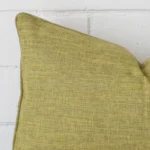 Close up image of top corner of this olive cushion. This shows the linen fabric and rectangle shape up close.