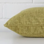 The seams of this linen square cushion cover in olive are shown. The image shows how the panels are attached.