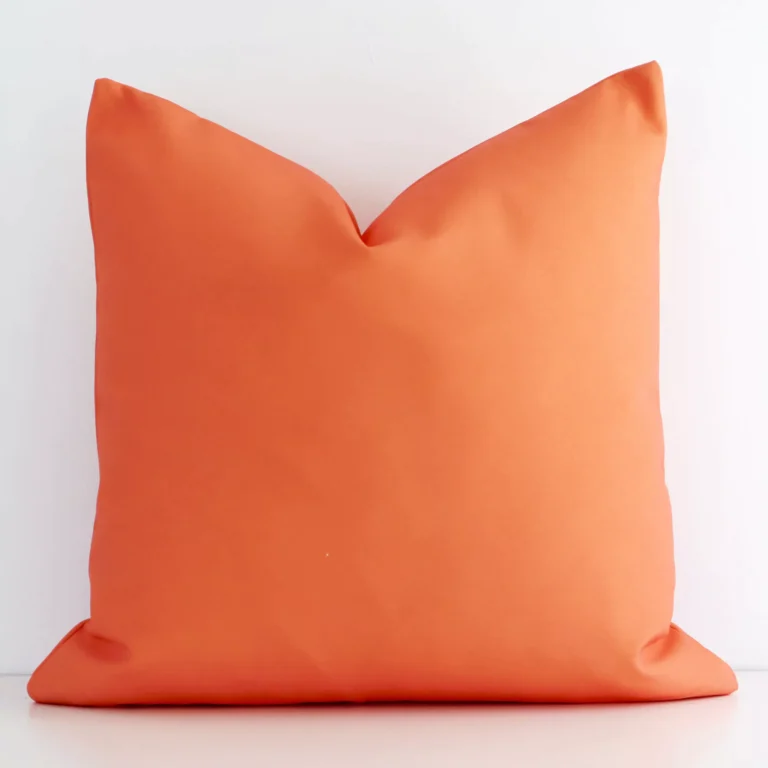 Lovely bold coral cushion made from outdoor fabric and in an elegant square shape.