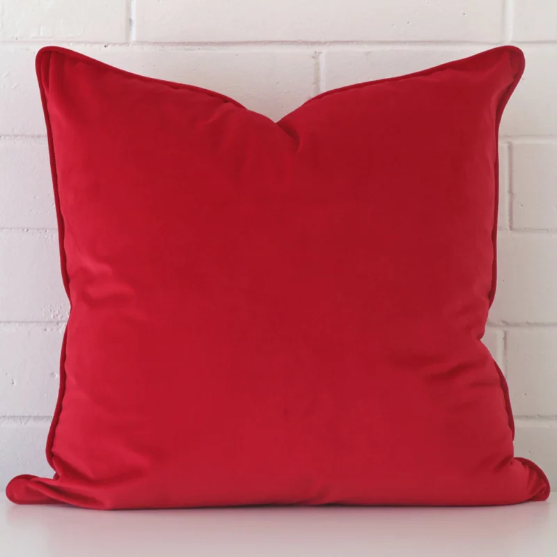 cerise-red-velvet-cushion-cover-55cm-x-55cm-sc497-55b A brick wall that has a red cushion cover positioned in front of it. It has an exquisite velvet material and a lovely large size.