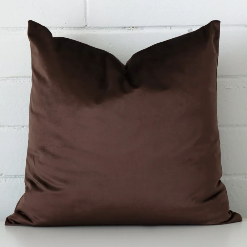 chocolate-brown-velvet-cushion-cover-sc1050-45b Here a brown velvet cushion is shown styled against a white wall. It has a square design.