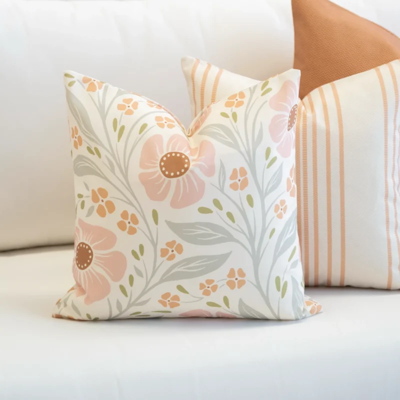 3 outdoor cushions from the Claybourne set sitting on white sofa.