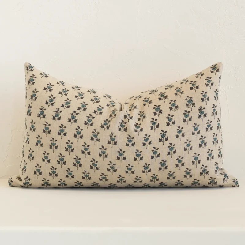 cleo-floral-designer-cushion-cover---rectangle---art130-30 Sand-coloured floral cushion cover sits against a white wall. It is constructed from a superior looking linen material and has rectangle dimensions.