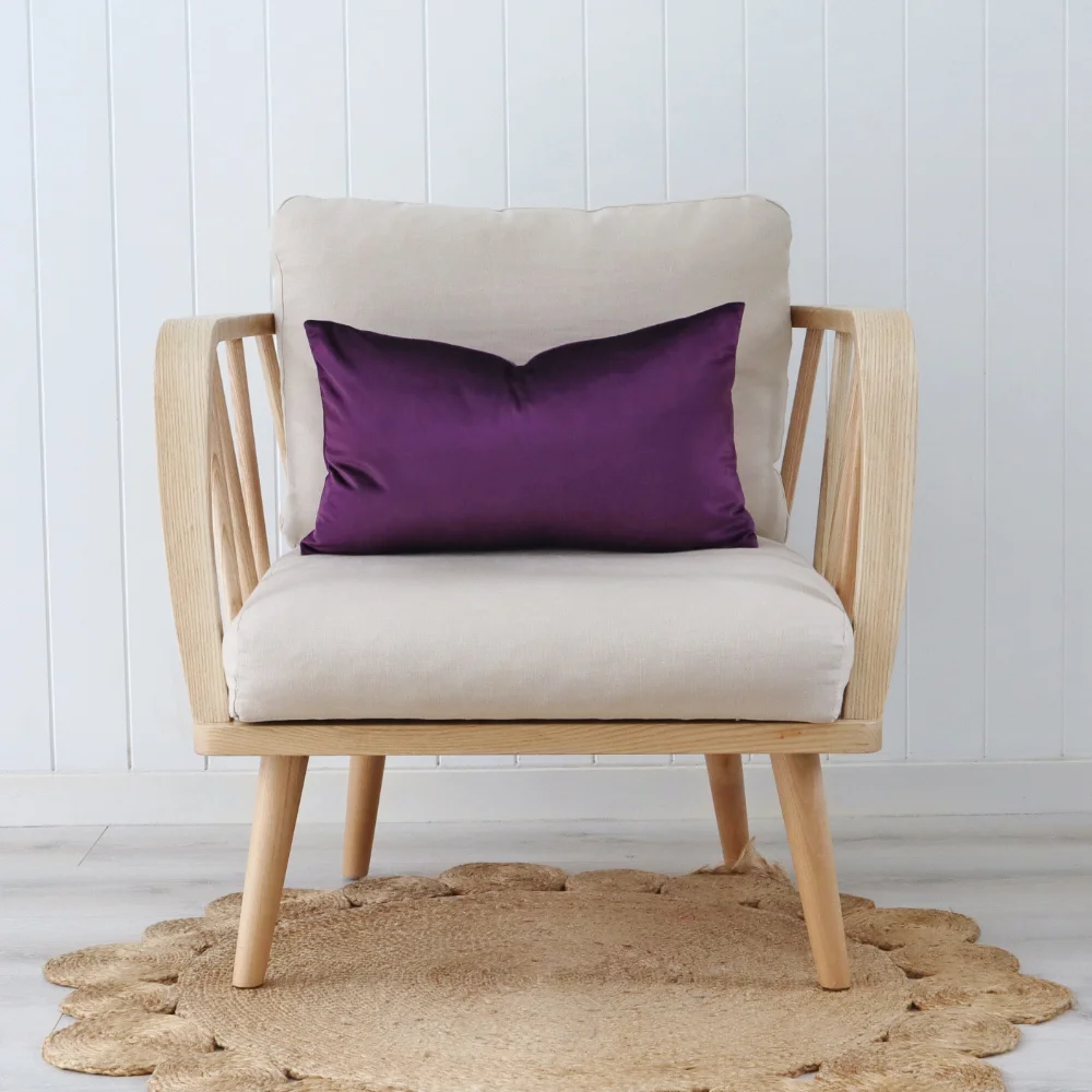 A contemporary chair with a purple cushion in its middle.