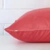 Side image of a velvet large cushion cover. The coral colour is more visible in this up close shot.