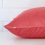 Side image of a velvet large cushion cover. The coral colour is more visible in this up close shot.