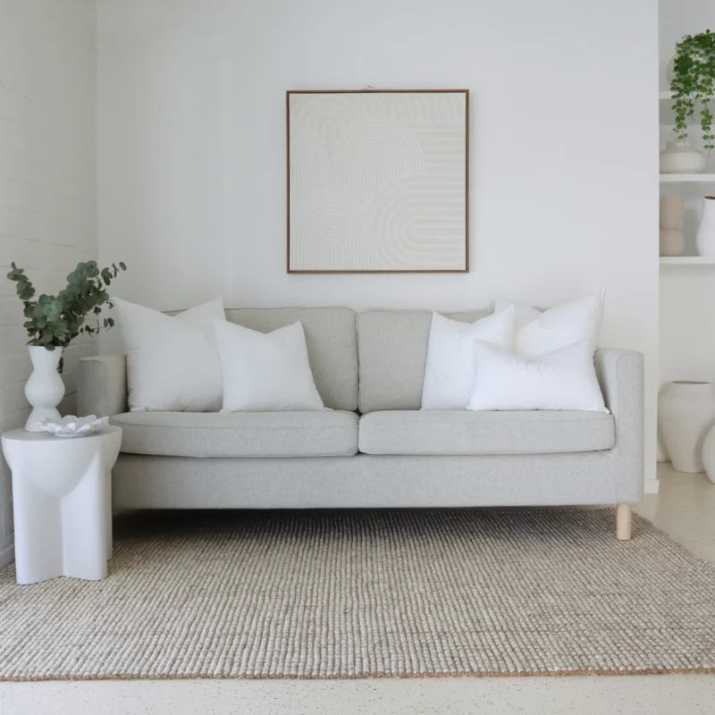 cushion-insert-faux-feather-sofa-set-of-5 5 cushion inserts made from faux feather are displayed in a bright living room.