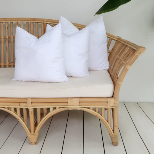 3 cushions inserts in a corner of a rattan seat.