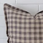 A magnified shot of a gingham designer cushion cover in a large size.