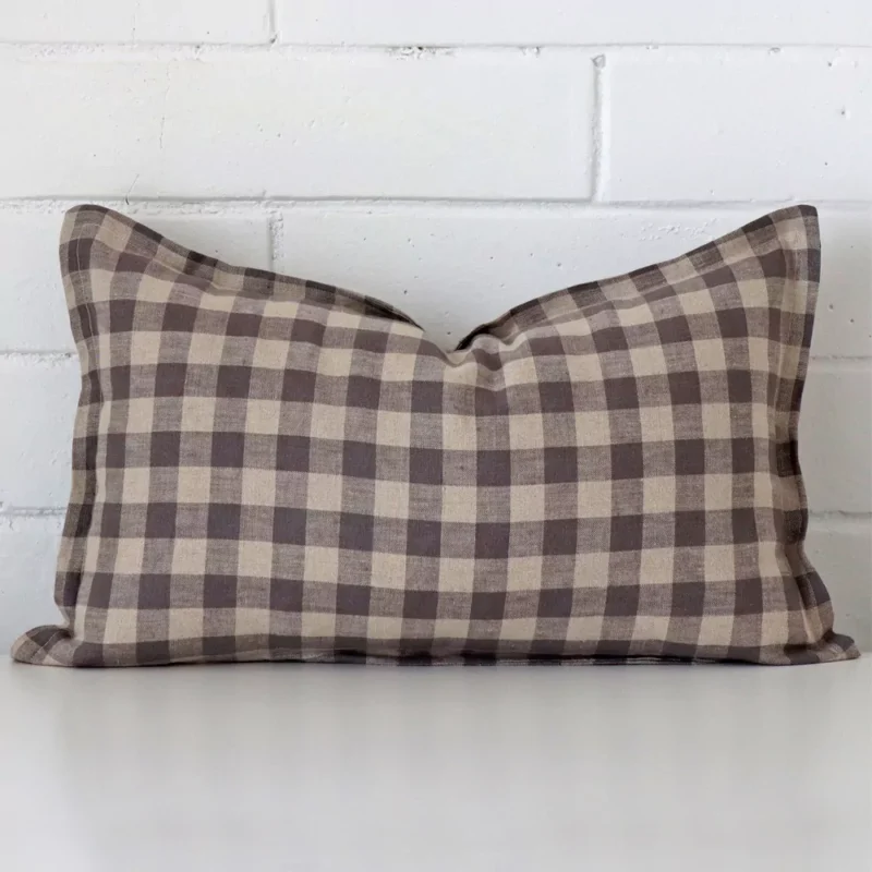 darcy-gingham-designer-cushion-cover-rectangle-art121-30b Here a designer cushion is shown styled against a white wall. It has a rectangle design and features a gingham style.