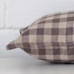 The seams of this designer rectangle cushion cover in is shown. The image shows the gingham design and how the panels are attached.