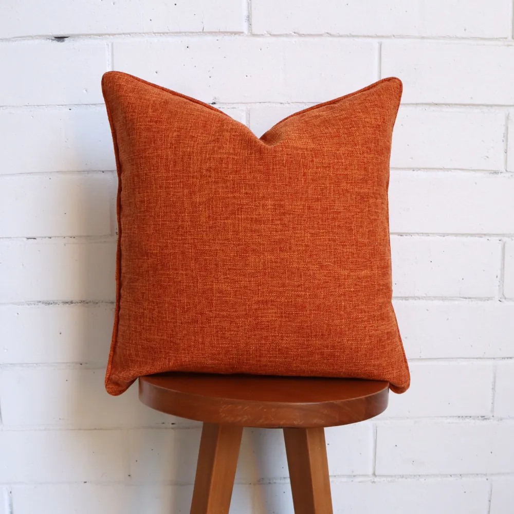 A dark high chair displaying a terracotta cushion.