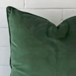 A dark sage velvet cushion cover’s corner is shown in more detail. It has a large size.