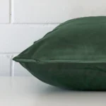 Side shot showing the seam of this large dark sage cushion that features velvet material.
