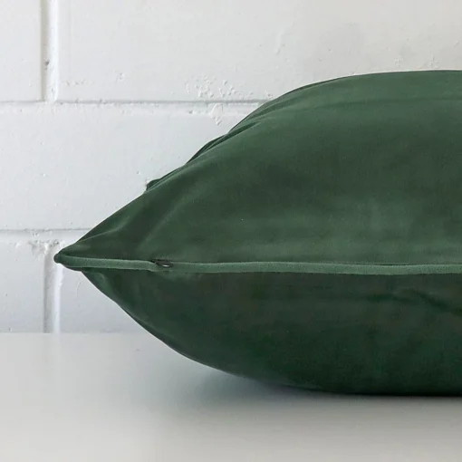 Side shot showing the seam of this large dark sage cushion that features velvet material.
