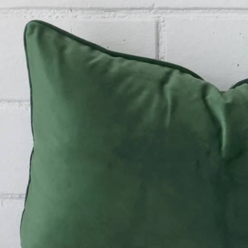 Zoomed photo of the top left corner of this dark sage cushion cover. The image clearly shows the linen material and square dimensions.