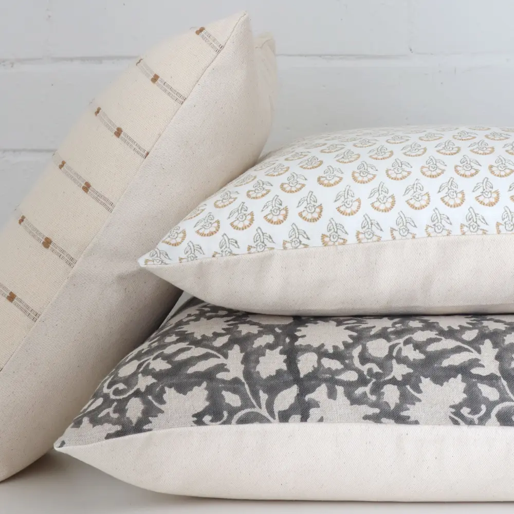 A detailed view of some Indian block printed cushions from a side angle.