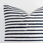 Close range image of striped linen cushion. The large size and linen material can be seen in detail.