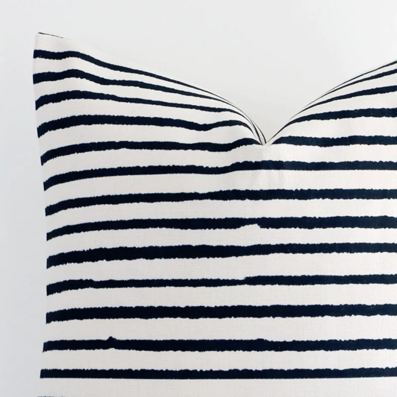 Close range image of striped linen cushion. The large size and linen material can be seen in detail.