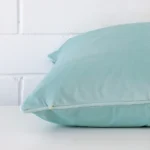 Lateral angle image of a velvet large cushion. It has a pretty duck egg colour.