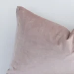 dusty-pink-velvet-linen-rectangular-cushion-cover---30cm-x-50cm---sc508-30b Rectangle solid-coloured cushion in dusty pink colour sitting upright in front of a white wall. It has been made from a quality velvet material.