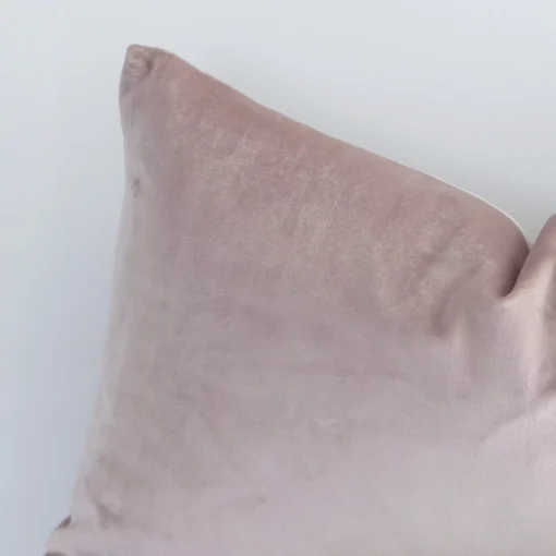 dusty-pink-velvet-linen-rectangular-cushion-cover---30cm-x-50cm---sc508-30b Rectangle solid-coloured cushion in dusty pink colour sitting upright in front of a white wall. It has been made from a quality velvet material.
