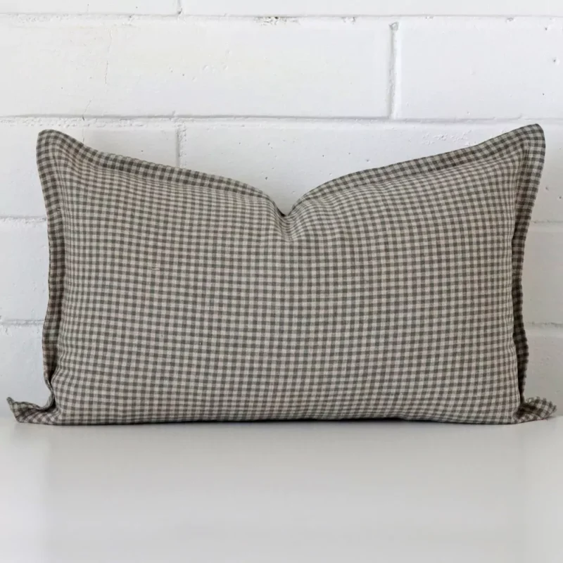 eden-gingham-designer-cushion-cover-rectangle-art119-30b A designer rectangle cushion cover that has a unique gingham design is shown vertically against a brick wall.