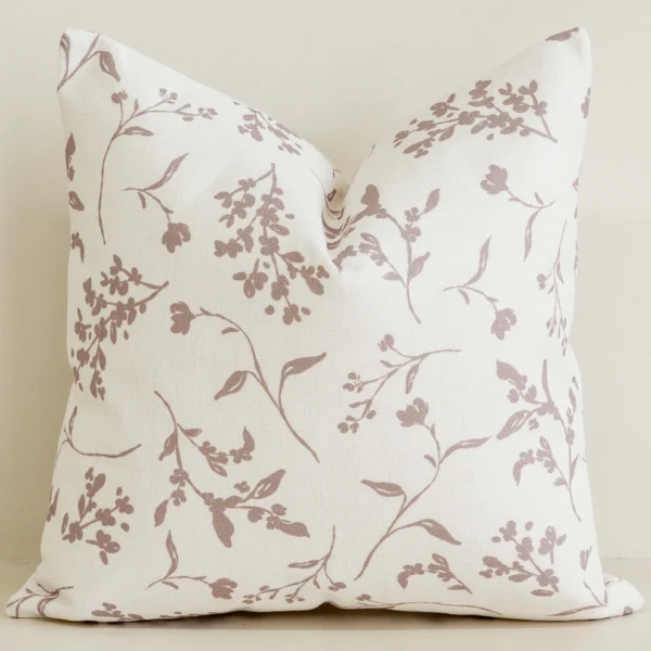 Cream cushion cover with soft blush botanical branch print.