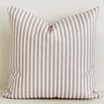 Dusty pink striped cushion cover on cream cotton-linen base.