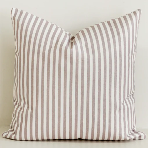 Dusty pink striped cushion cover on cream cotton-linen base.