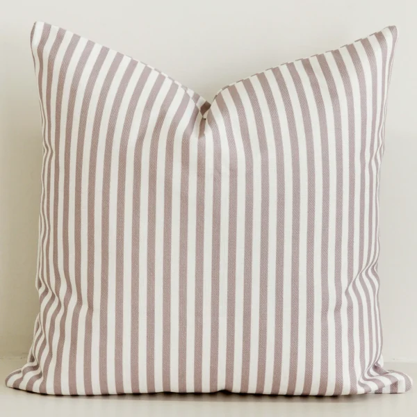 Dusty pink striped cushion cover on cream cotton-linen base.