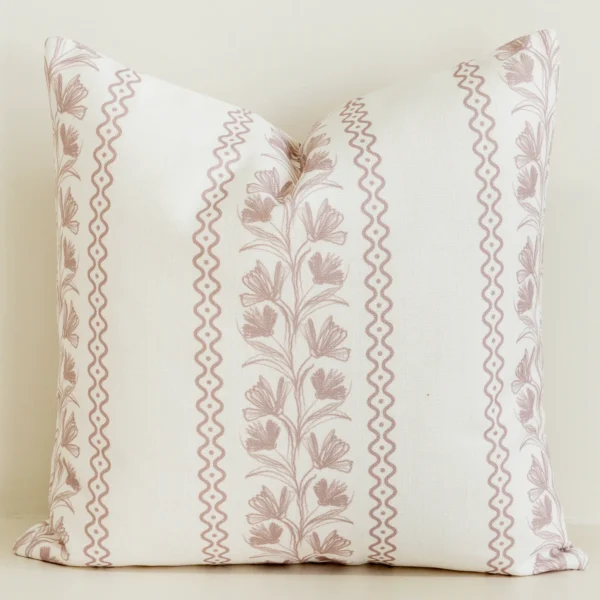 Cream cushion cover with pink floral stripe and wave trim.