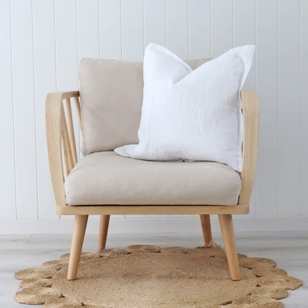 An elegant modern chair with a white cushion placed just off centre.
