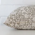 Side angle of grey floral cushion cover that has linen fabric and a rectangle size.
