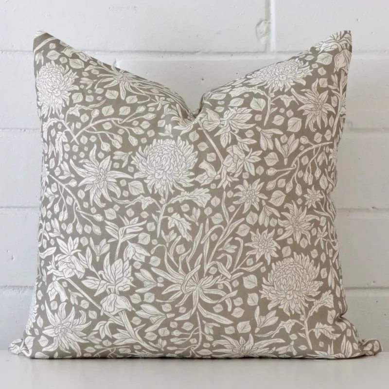 eliza-linen-grey-floral-cushion-cover-sc1012-45 A linen square cushion cover that has a unique floral design is shown vertically against a brick wall. It has a wonderful grey colour.