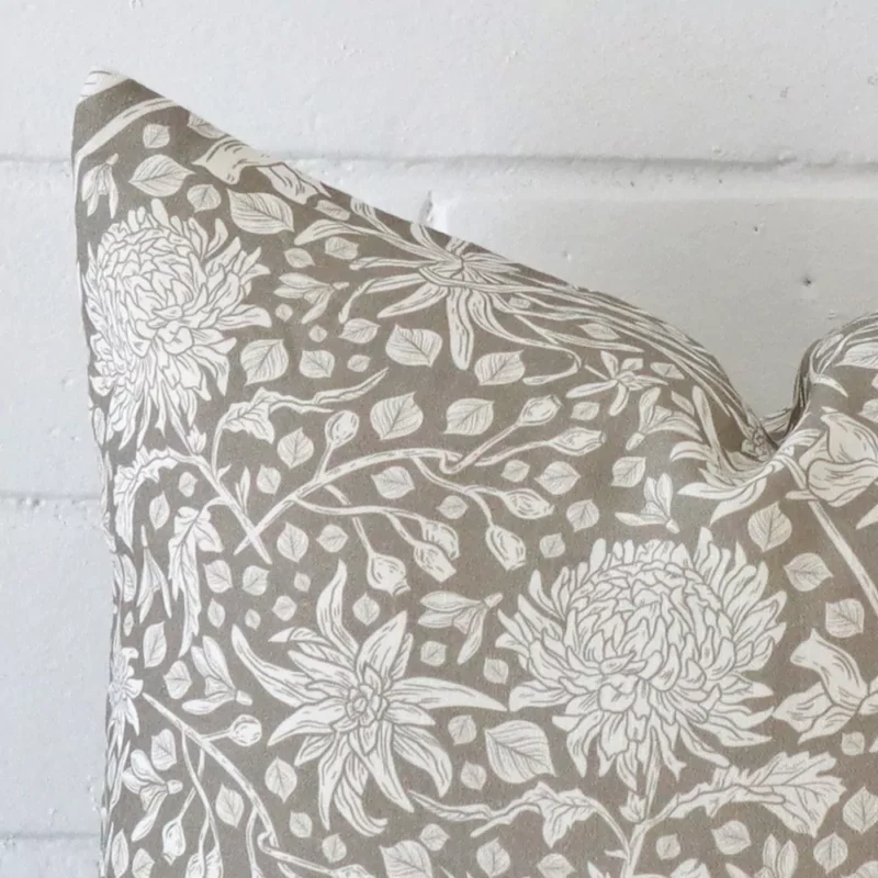 A very close image of the corner of a linen cushion.The finer detail of the square shape and grey colour are visible.