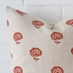 Zoomed photo of the top left corner of this rust floral cushion cover. The image clearly shows the linen material and large dimensions.