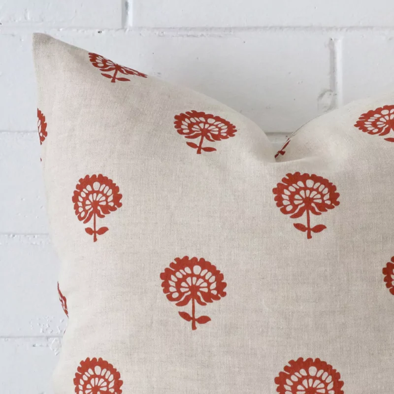 Zoomed photo of the top left corner of this rust floral cushion cover. The image clearly shows the linen material and large dimensions.