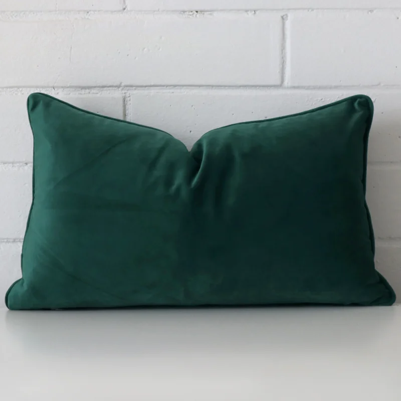 emerald-green-rectangular-velvet-cushion-cover-30cm-x-50cm-sc499-30 A pretty velvet cushion cover is shown against a brick wall. It features a rectangle shape and an emerald green colour finish.