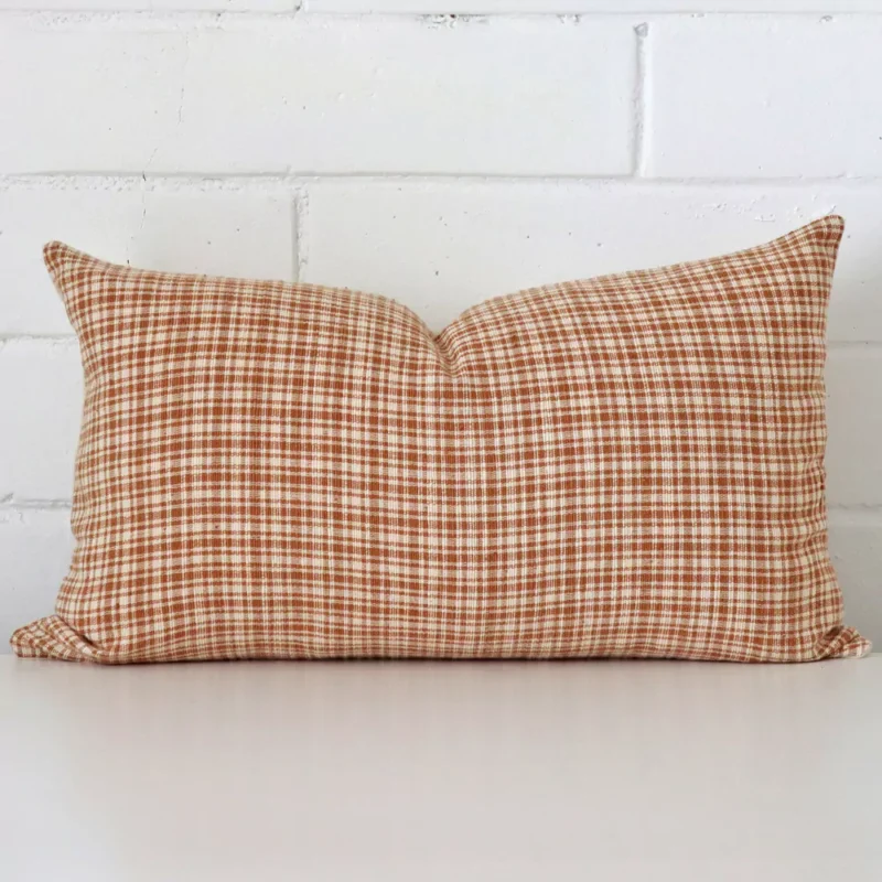 enid-gingham-designer-cushion-cover-rectangle-art108-30b A rectangle gingham cushion in a delightful tone rests against a white wall. The designer material appears to be of exceptional quality.