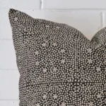 This image shows a cushion cover from a very close range. The large size and designer material are more clearly shown.