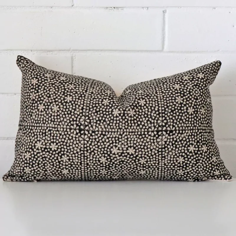 essa-designer-cushion-cover-rectangle-art115-30b Cushion leans elegantly against a brick wall. It has been crafted from a high quality designer material and has a rectangle shape.