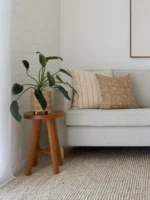 A grey sofa is adorned with the elegant Essa sofa cushions, a set of five designer cushions.