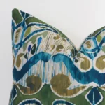 Focused view of patterned square cushion cover. The shot shows details of its linen material and colourful colour.