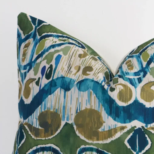 Focused view of patterned square cushion cover. The shot shows details of its linen material and colourful colour.