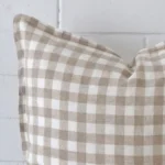 Extreme close up of a large cushion. The gingham style and designer fabric are shown with a much higher degree of detail.